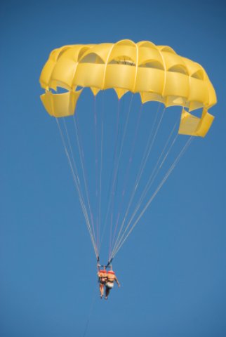 Couple parasailing over Smathers Beach Florida